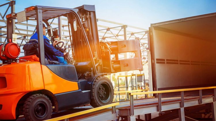 LP forklift unloading pallets from a semi-truck