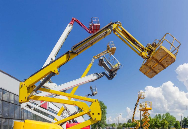 A variety of articulating lifts for sale outside