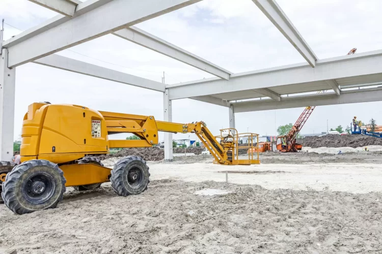 Large yellow boom lift outside at a construction site